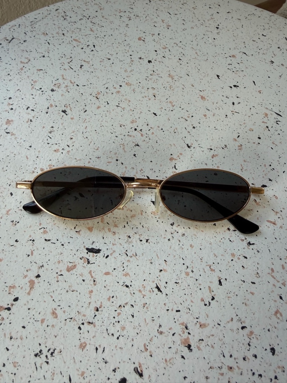 Slim Oval Gold Frame Sunglasses with Dark Lenses
